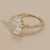 Top view of diamond accents on gallery of radiant cut engagement ring 14kt yellow gold