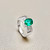 3.22tcw oval emerald and diamond ring on hand model 18kt white gold