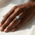Black diamond ring for women with white diamond accents, shown on hand, 14K white gold cluster setting