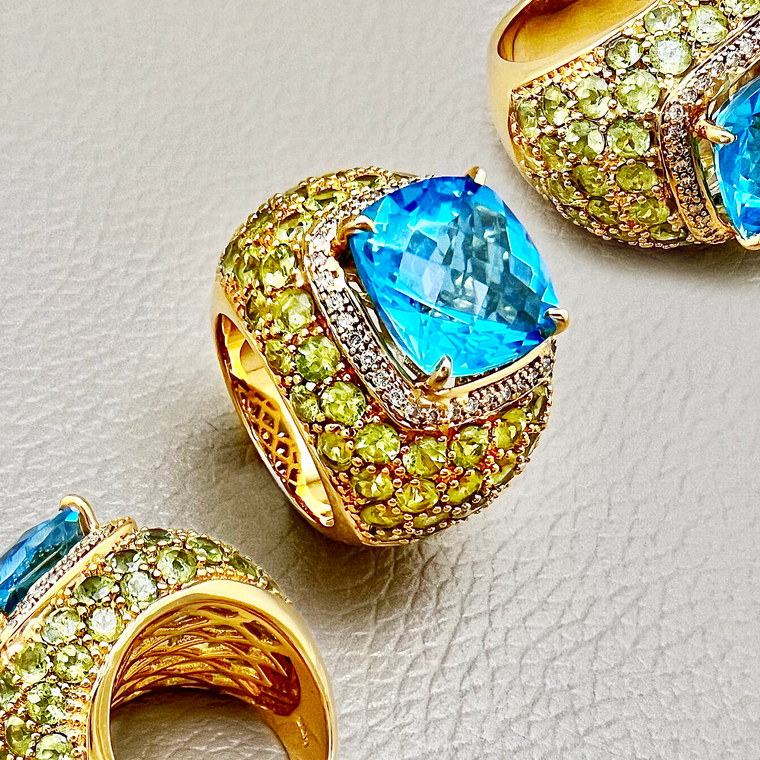 Close-up shot of extravagant Blue Topaz Cocktail Ring featuring peridot accents