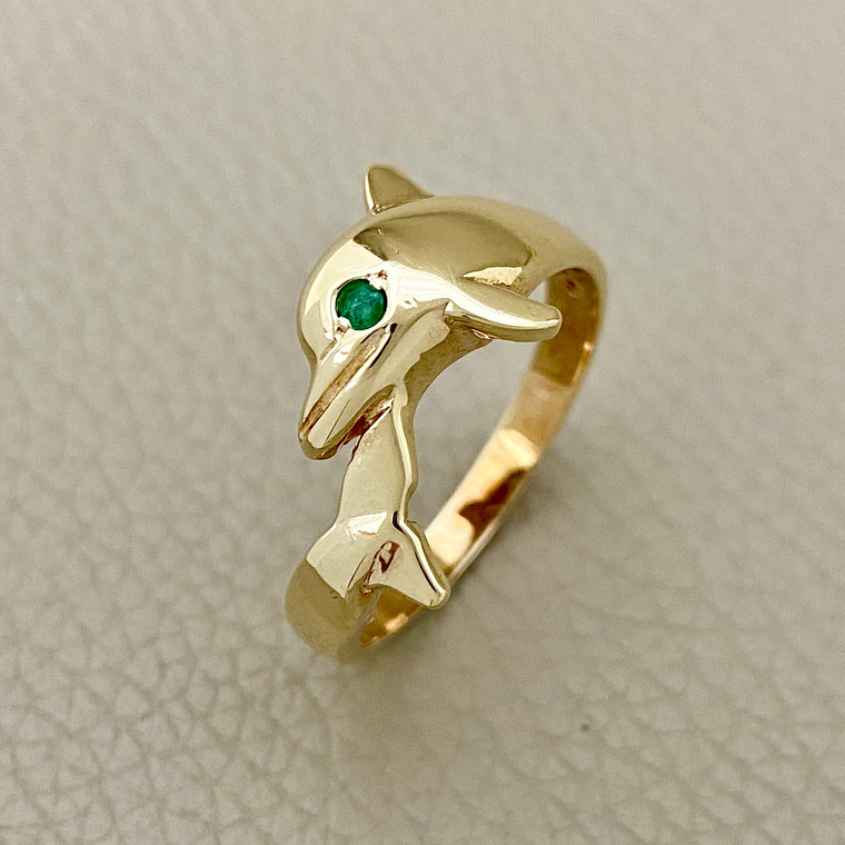 Dolphin ring 0.05tcw with round emerald eyes, set in 14kt yellow gold. A unique and playful ring for women from Treasured & Co., Astoria.