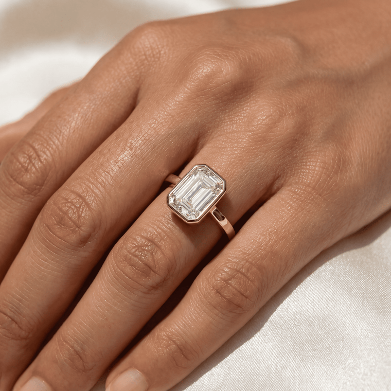 Emerald-cut diamond engagement ring in solitaire setting — front view