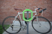 Secure and robust two-bike rack by Frost, model 2070-Green, in a striking green color, perfect for enhancing outdoor spaces while providing a bike-friendly environment.