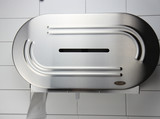 The Frost 169 Twin Jumbo Toilet Tissue Dispenser made of stainless steel, featuring a sleek design and a convenient side window for easy monitoring of tissue levels. On wall