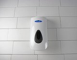 Frost 702 plastic manual foam soap/sanitizer dispenser in white, highlighting its sleek body, transparent level indicator, and ergonomic dispensing button.