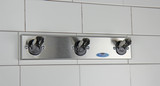 The Frost 1150-3-SS Safety Coat Hook Strip mounted on a wall, showcasing its sleek stainless steel design and the safety hooks that fold down for added protection and space efficiency.