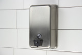 The Frost 708A is a robust vertical stainless steel liquid soap dispenser with a secure lock at the bottom, suitable for maintaining hygiene in high-use commercial or public restrooms.