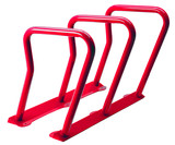 The durable and secure Frost 2090-Red steel bike rack, capable of accommodating six bicycles, stands out in a bold red, perfect for enhancing outdoor communal areas.