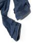 Close-up hem details of men's Loose J58 vintage Levi's Engineered Jeans with sloped cuffs being prepared for specialized hemming service to shorten the inseam length.
