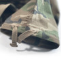 A close-up of the hem of camouflage drawstring pants with buttonholes after hemming alterations to shorten the inseam.