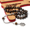 Brown Tasbih Prayer Beads Displayed on Wooden Islamic Decor
