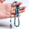 Hand Holding Blue Rain Stone Muslim Prayer Beads