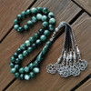 Green Marbled Saudi Prayer Beads on Wooden Surface with Silver Tassel