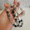 Natural Stone Tasbih Prayer Beads held in Hand for Size Reference