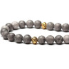 Close-up of natural stone tasbih showing gold tassel and bead pattern