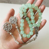 Handheld green stone prayer beads with decorative silver accents