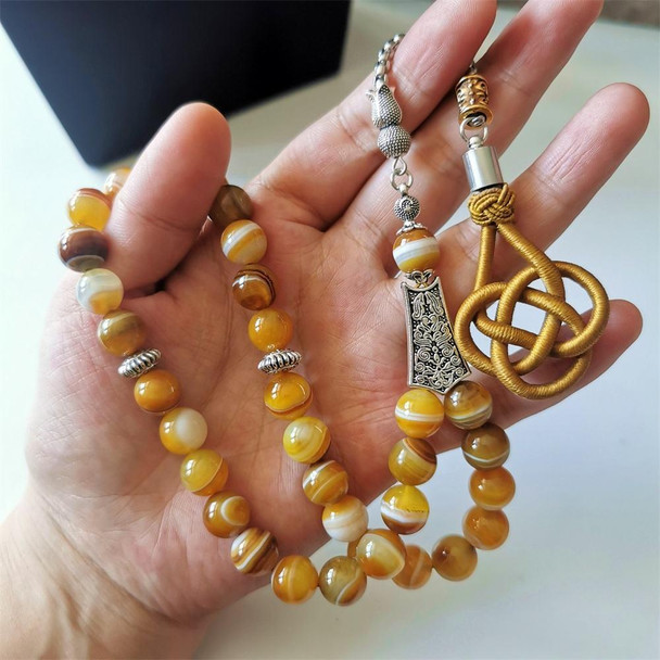 Handheld agate prayer beads featuring natural striped stone patterns