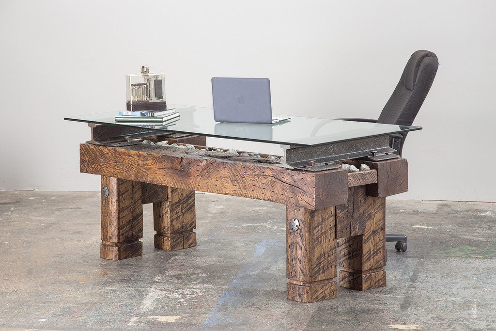 expensive executive ceo desk with reclaimed oversized historical industrial artifacts
