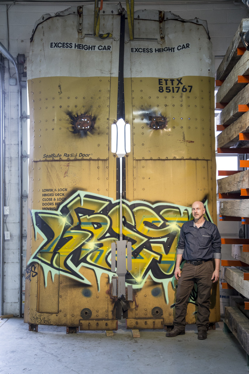 Large-scale graffiti panel in metallic copper on rusted steel