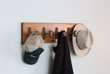 natural wood finish coat rack with reclaimed steel hooks from architectural artifacts for modern industrial style commercial or residential interiors