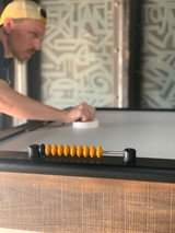 Air Hockey Player backed by graffiti