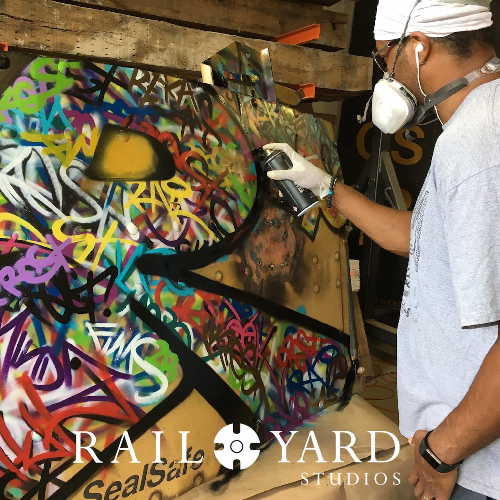 graffiti artist tagging steel railroad panel