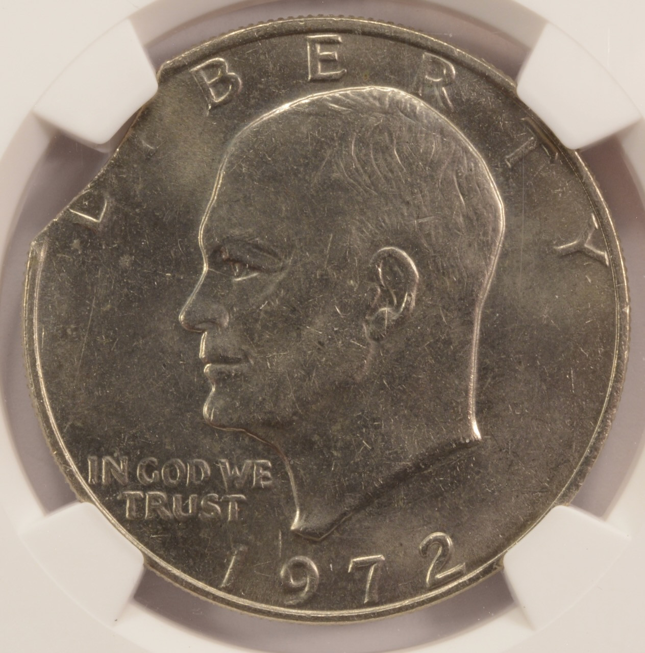 1972 $1 Ike Dollar 3% Curved Clip at K-10 NGC MS62