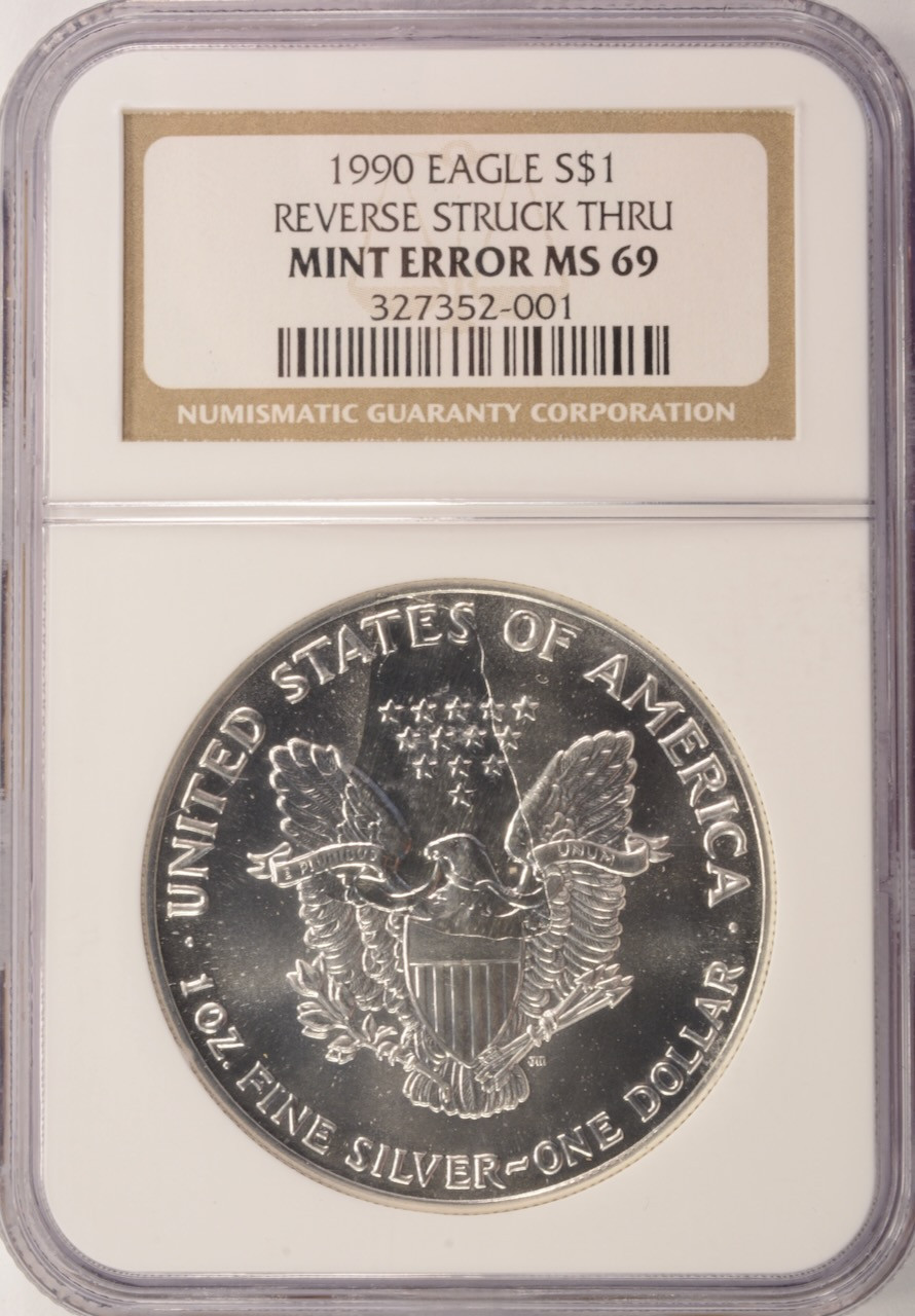 1990 $1 Silver Eagle Struck Thru Reverse NGC MS69