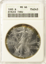 1995 $1 Silver Eagle Struck Thru Obverse at 3:00 ANACS MS66
