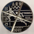 1995 proof track and field Olympic die, used for striking silver dollar track and field commemorative coins for the 1995/1996 Atlanta Olympic games. The die was used for striking some of those coins, and then was retired and "cancelled" with an "X" shaped across the obverse side.