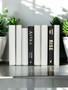 White parchment bound spines with a touch of modern hardbound books in black - (By the Foot)