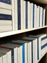 Natural parchment bound spines with a touch of modern hardbound books in varied blue tones for a very clean look. Book covers vary.- By the linear foot/ 8.5"-9.5"