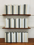 50 Vol. White, natural and gray parchment bound spines.