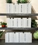 White parchment bound books with a touch of faux titles. Book covers vary.- 50 books/ 8.5"-9.5"