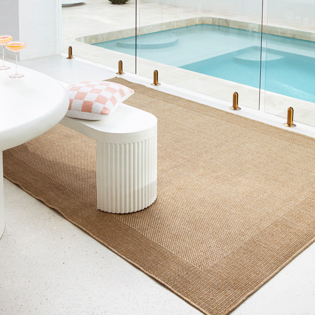 Outdoor rug near swimming pool on patio