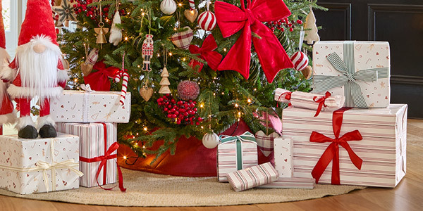 Wrapped Christmas gifts sit underneath a Christmas Tree