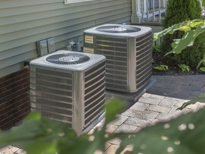 Two Central Air Conditioning Units Next to a Home