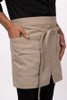 Close-up of curved hem and front slit for mobilityKhaki Logan Half Bistro Apron Pocket Detail
