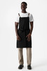 Front view of Tactical Bib Apron in Black from 25/Seven Workwear with utility pockets and crossback straps