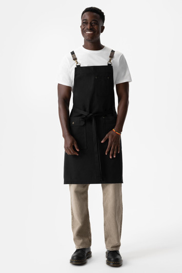 Front view of Tactical Bib Apron in Black from 25/Seven Workwear with utility pockets and crossback straps