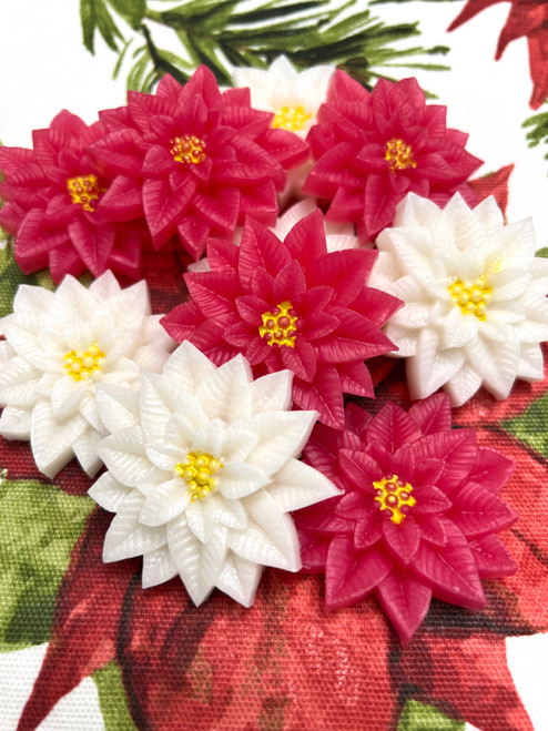Mini poinsettia soaps with yellow mica centers, customizable in red, white, or pink, perfect for holiday decor and soap projects.
