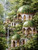 Elven-style domed buildings with emerald roofs surrounded by waterfalls and lush green forest.