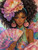 Elegant woman surrounded by pink peonies holding a floral fan while wearing ornate jewelry and a beautifully detailed gown.
