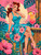 Redheaded retro pin-up woman in turquoise tropical dress beside a colorful cocktail, bamboo, and pink hibiscus flowers.