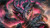 Massive black dragon with glowing pink wings and turquoise eyes curling around rugged mountain peaks.