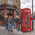 Louise's Pub by Kristin Schwenke Block featuring London punk rockers with colorful mohawks and leather jackets beside a red British telephone box and pub