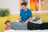 Practitioner using the emFieldPro medium dynamic applicator for contact-free treatment of the lower back