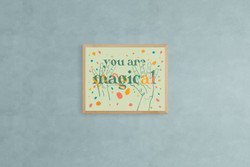 You Are Magical Art Print on a light blue wall.