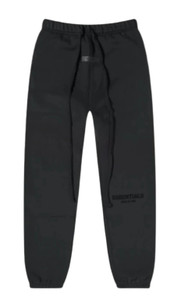 Cuffed black sweatpants with relaxed oversized fit and elastic waistband, front view