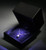 Black leatherette pendant box with black suede interior lit up by LED lighting